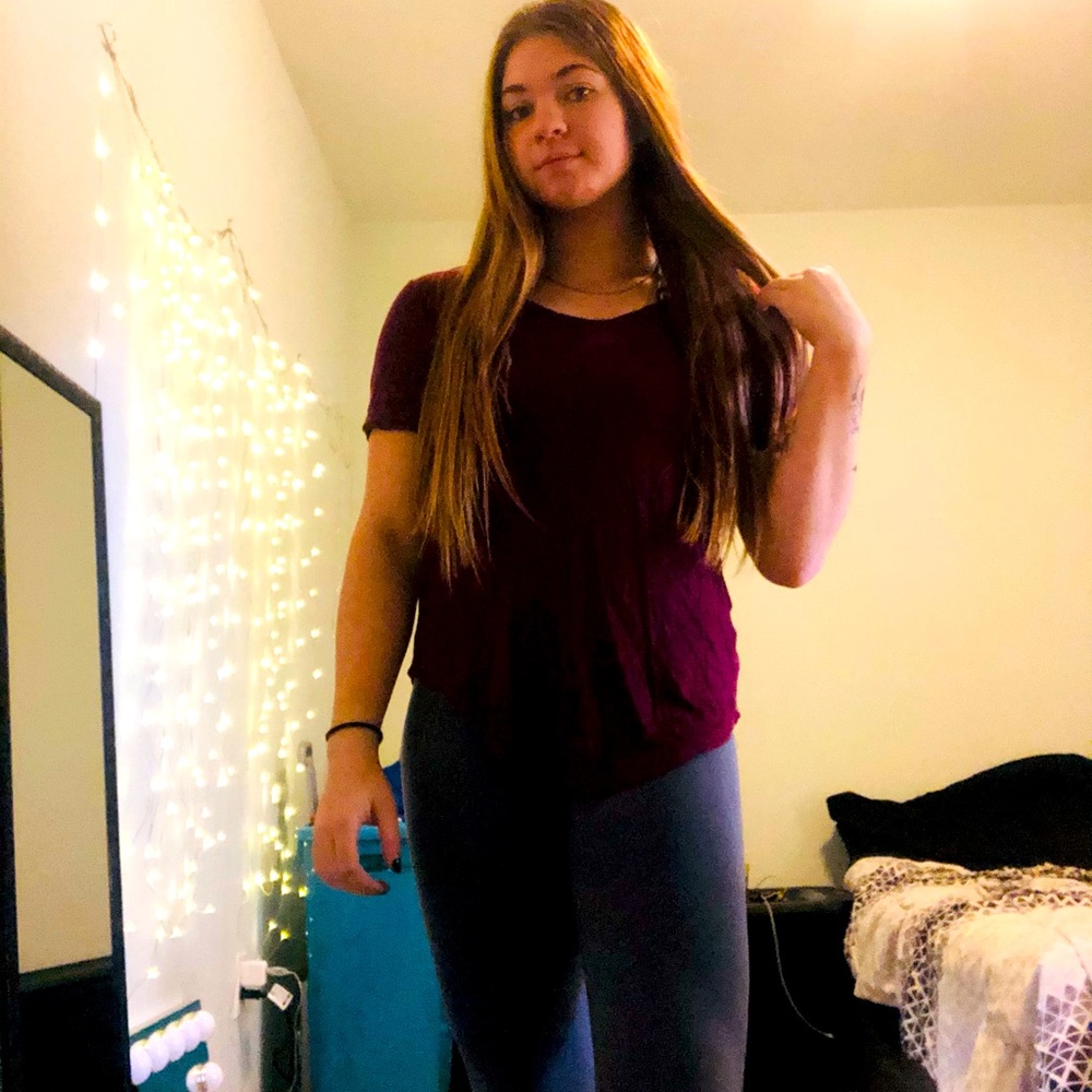 Thin burgundy shirt with cut out back. Size XS but fits like a S.